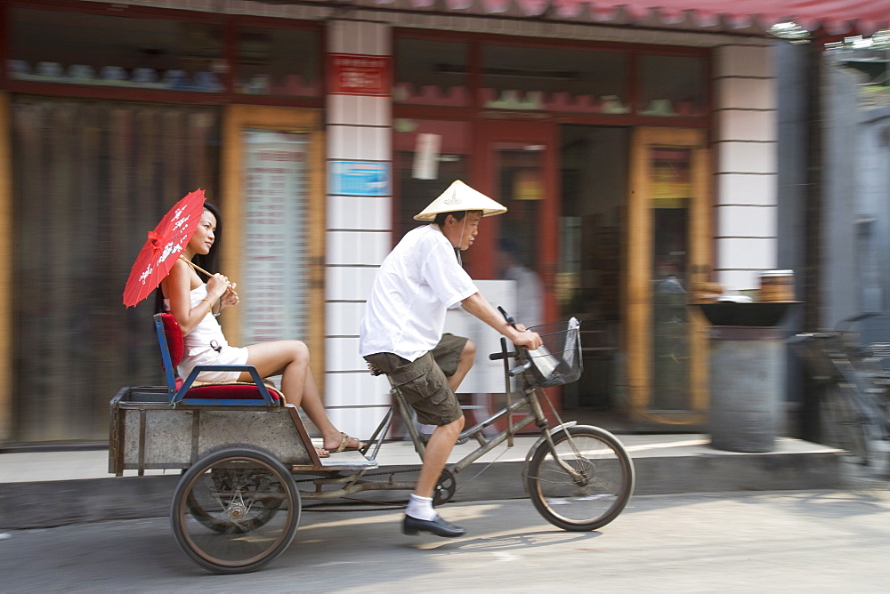 Asian woman (Chinese-Thai) riding in cycle rickshaw, Hutong District, Beijing, China, Asia