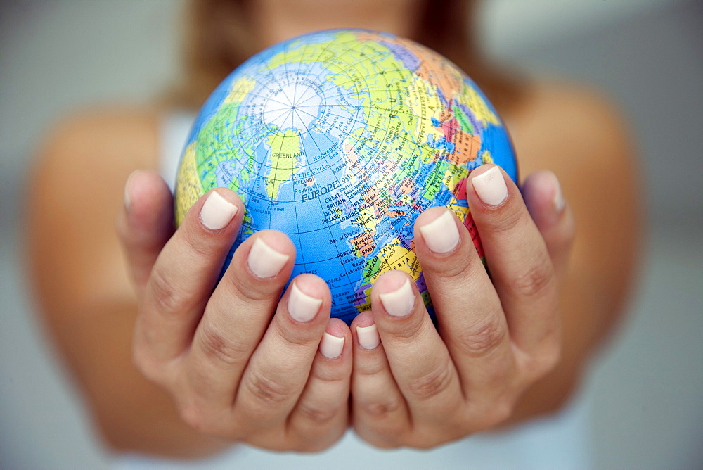 Woman's hands holding world globe