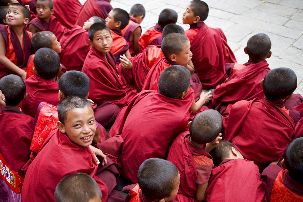 Monks watching religious dances, Buddhist festival (Tsechu), Trashi Chhoe Dzong, Thimphu, Bhutan, Asia