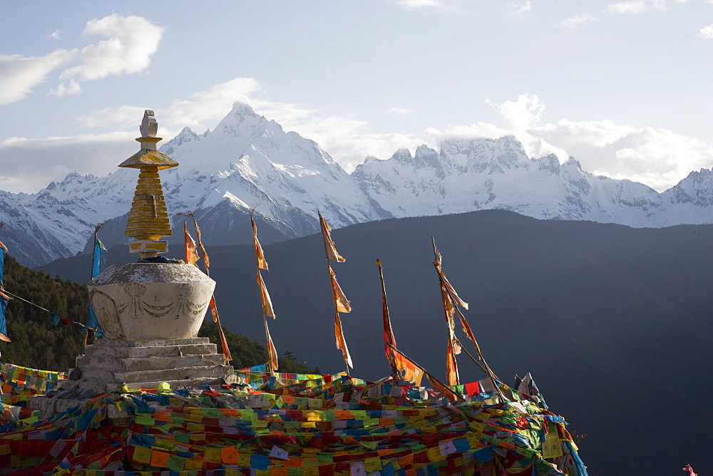 Buddhist stupa on way to Deqin, on the Tibetan Border, with the Meili Snow Mountain peak in the background, Dequin, Shangri-La region, Yunnan Province, China, Asia