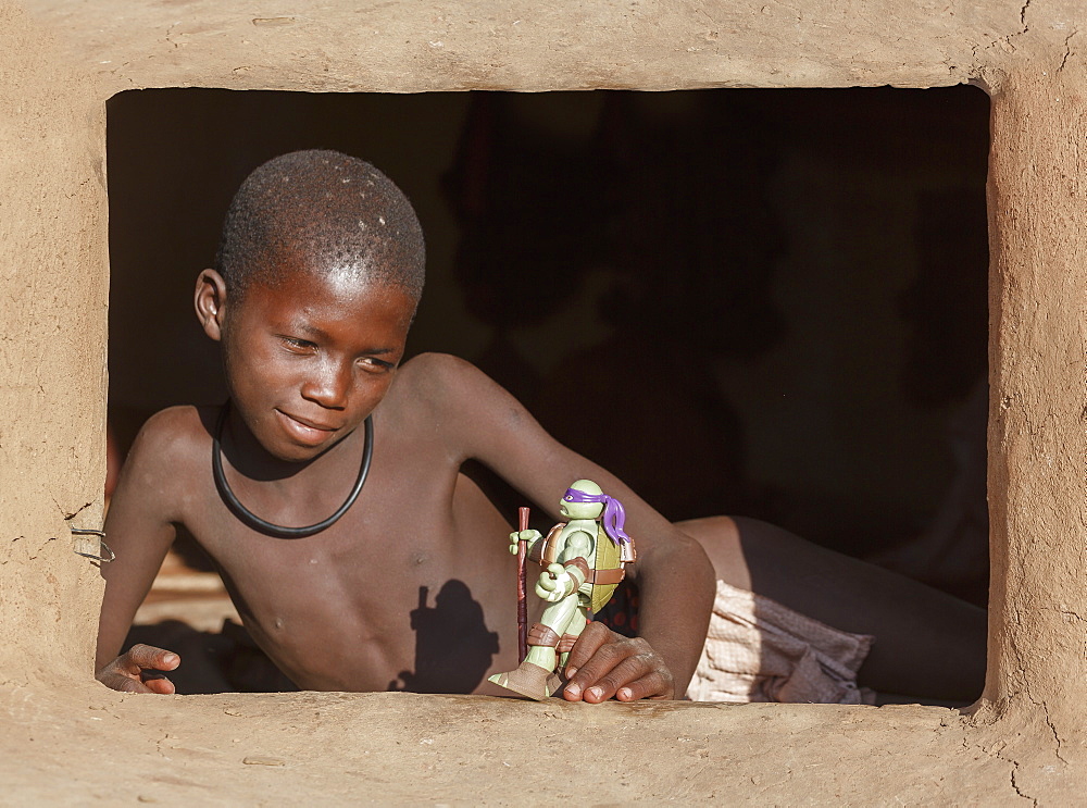 Himba boy with toy, Kaokoland, Namibia, Africa