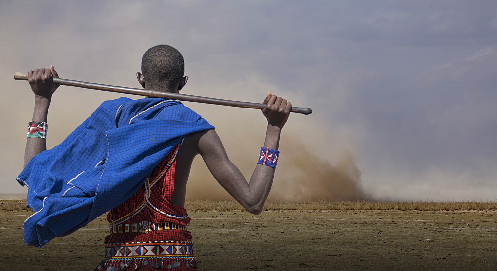 Masai man watching wind storm in Amboseli National Park, Kenya, East Africa, Africa