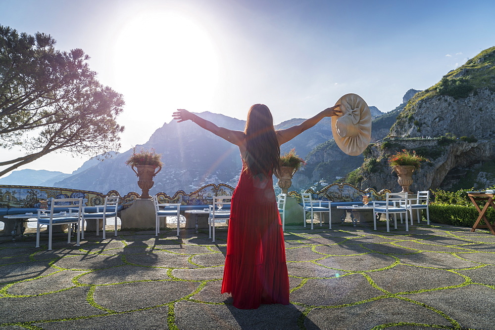 Woman with red dress on the Amalfi Coast, Campania, Italy, Europe