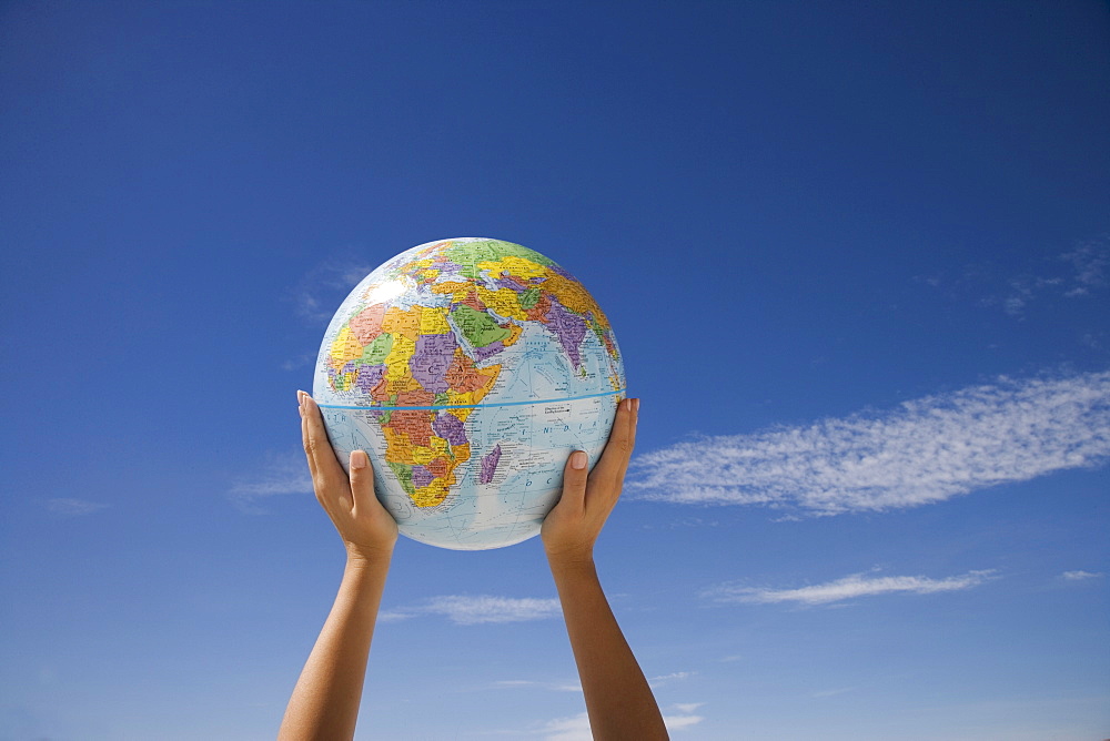 Woman's hands holding globe, Death Valley National Park, California, United States of America, North America