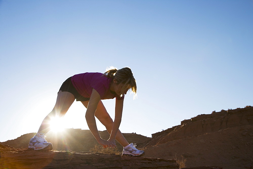 Woman stretching, Monument Valley Navajo Tribal Park, Arizona Utah border, United States of America, North America