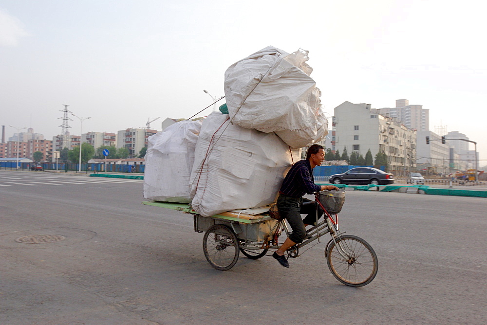 Transporting a precarious load through Beijing, China, Asia