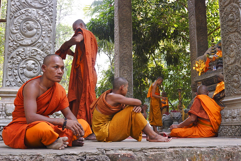 Buddhist monks relaxing amongst the temples of Angkor, Cambodia, Indochina, Southeast Asia, Asia