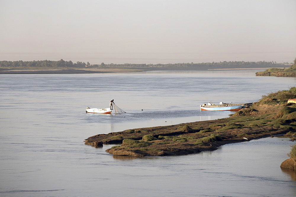 A fisherman checks his nets on the Nile river at Karima, Sudan, Africa