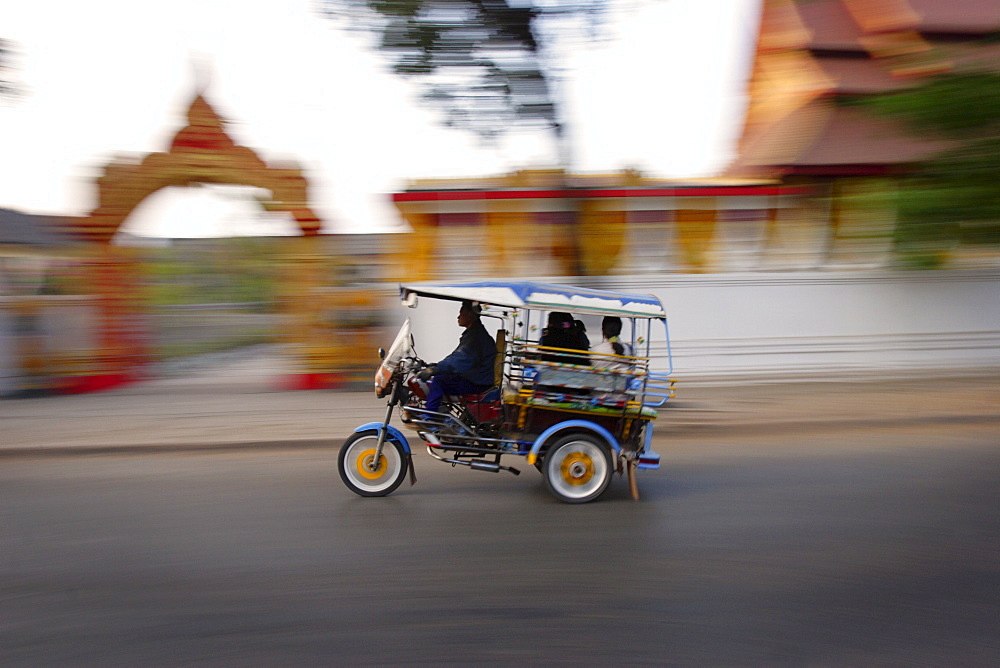 Tuk Tuk racing through Vientiane, Laos, Indochina, Southeast Asia, Asia