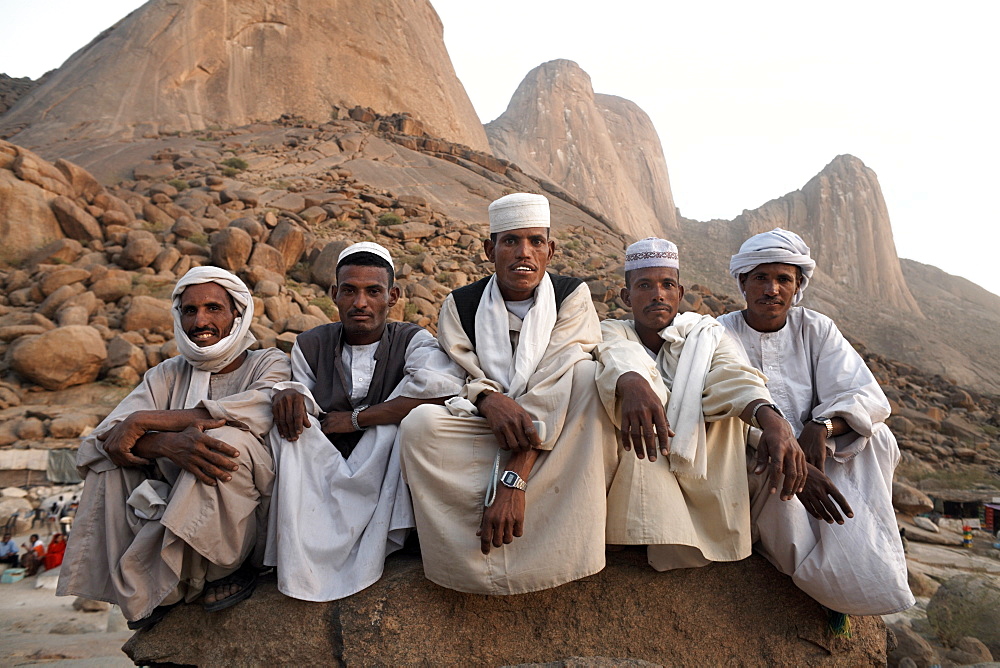 Muslim men relax in shadow of the Taka Mountain in the town of Kassala, Sudan, Africa 