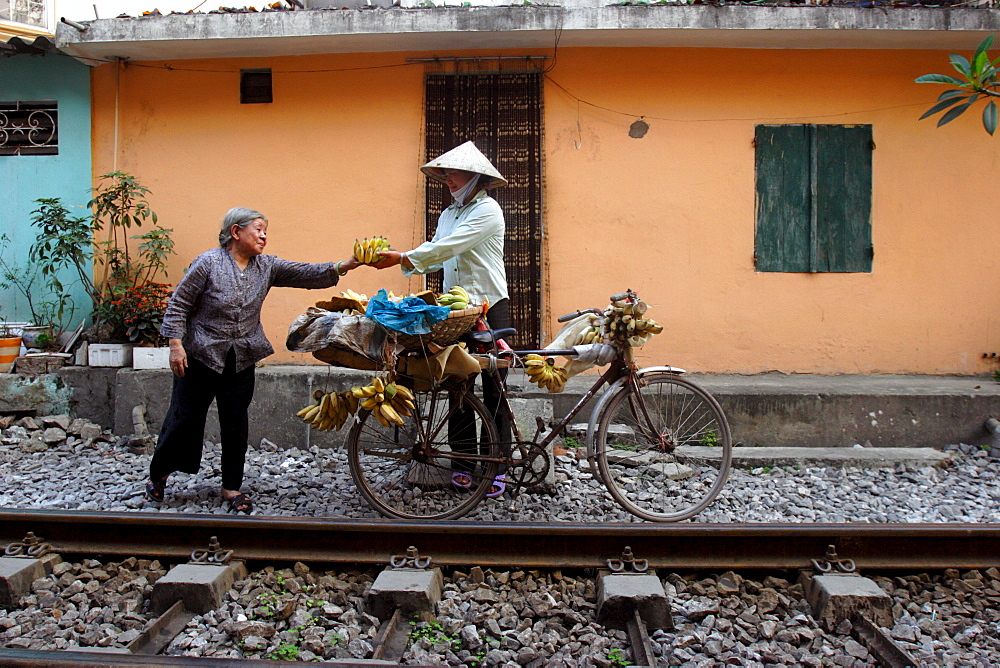 Selling bananas by the railway tracks in central Hanoi, Vietnam, Indochina, Southeast Asia, Asia