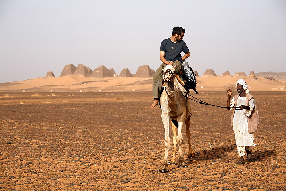 Tourists take camel rides at the pyramids of Meroe, Sudan's most popular tourist attraction, Bagrawiyah, Sudan, Africa