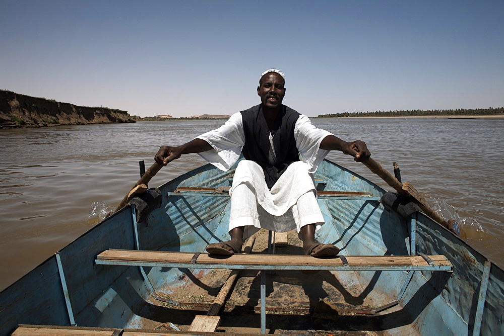 A boatman rows along the Nile river near Karima, Sudan, Africa