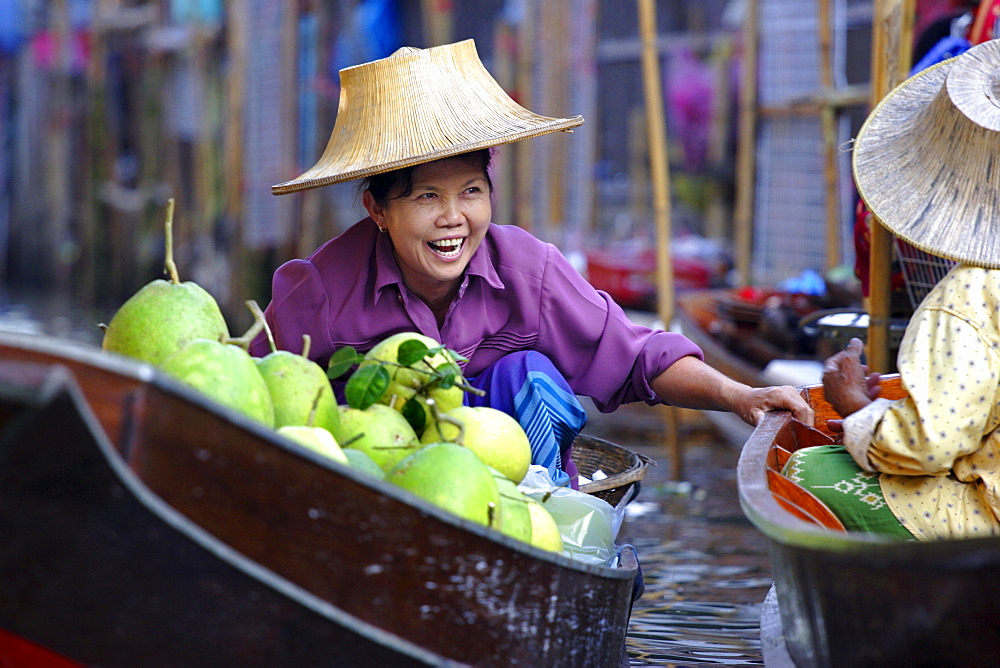 Local women share a joke at Damnoen Saduak Floating Market, Thailand, Southeast Asia, Asia