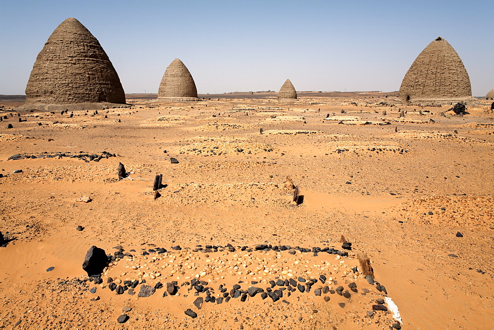 Graves, including beehive graves (Tholos tombs), in the desert near the ruins of the medieval city of Old Dongola, Sudan, Africa