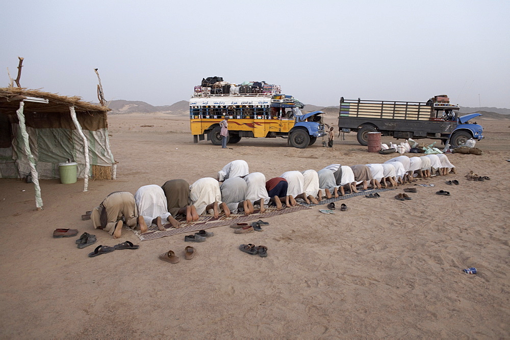 Muslims stop in the Nubian Desert for evening prayers, Sudan, Africa