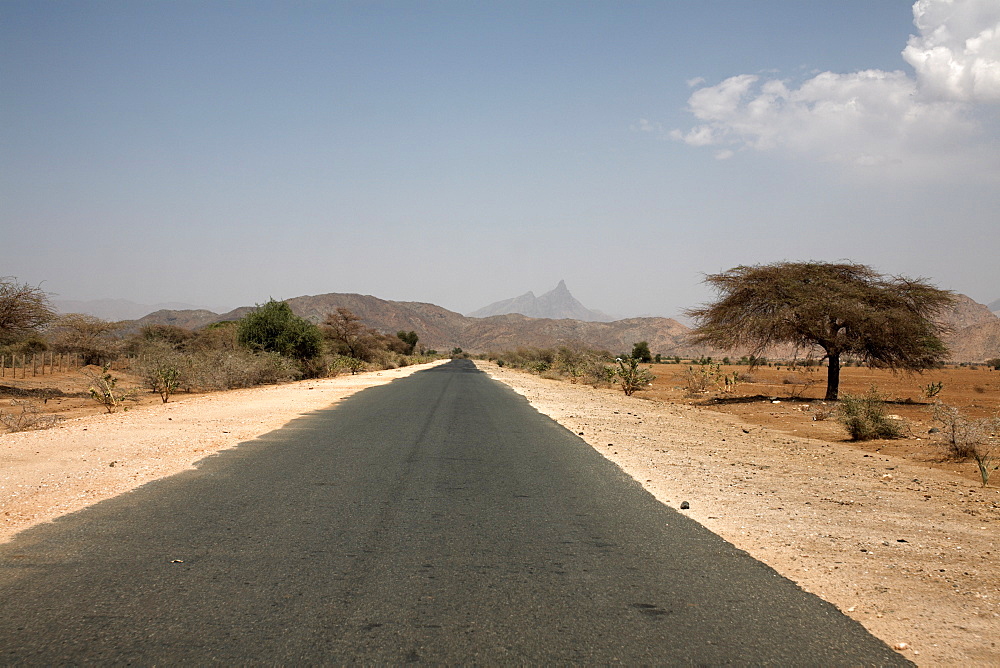 An empty road and the barren landscape of western Eritrea, Africa