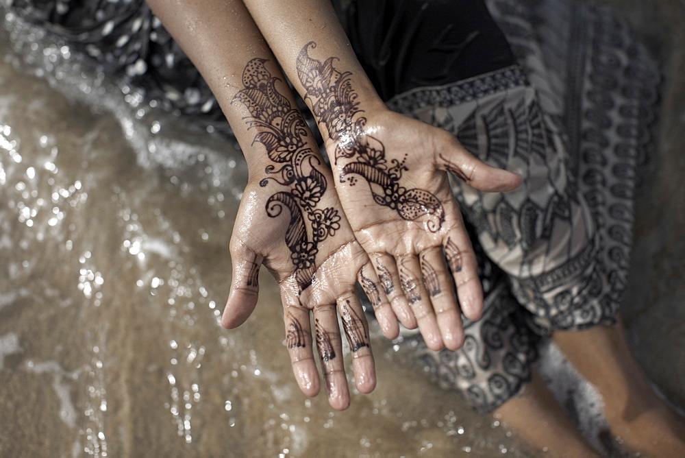 Henna adorn the hands of a Muslim woman on the beach at Berbera, Somaliland, Somalia, Africa