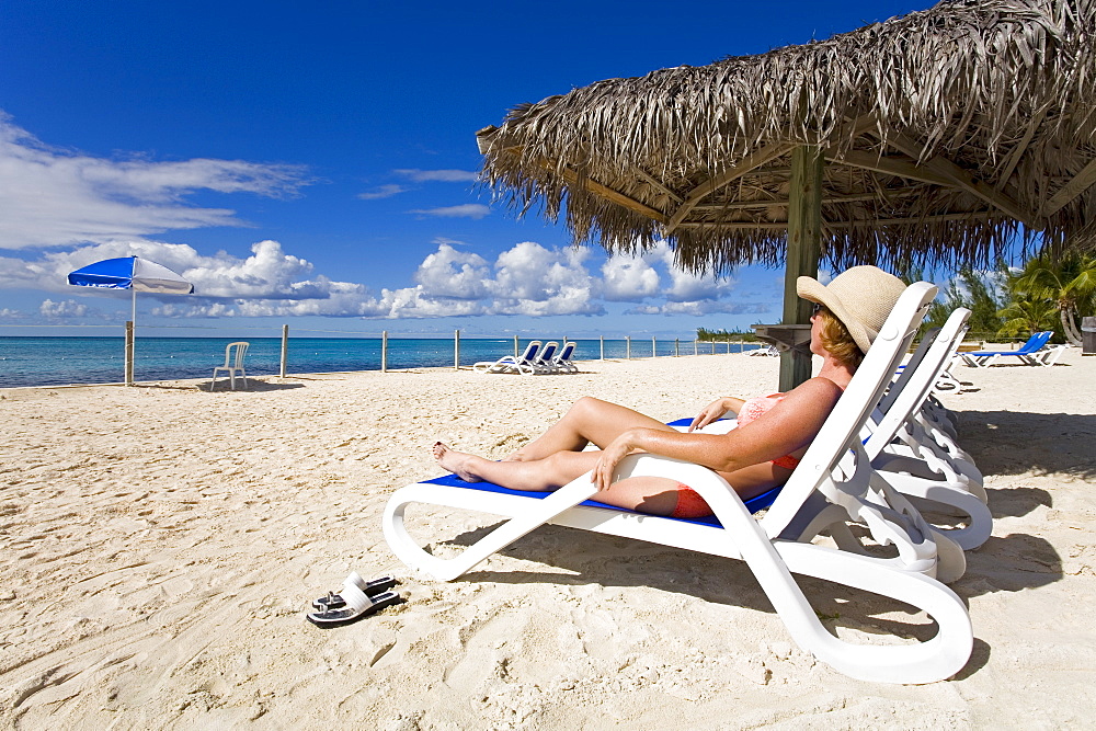 Woman on a lounger, Princess Cays, Eleuthera Island, Bahamas, Greater Antilles, West Indies, Caribbean, Central America