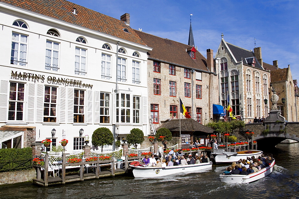 Tour boat on the canal in Bruges, West Flanders, Belgium, Europe