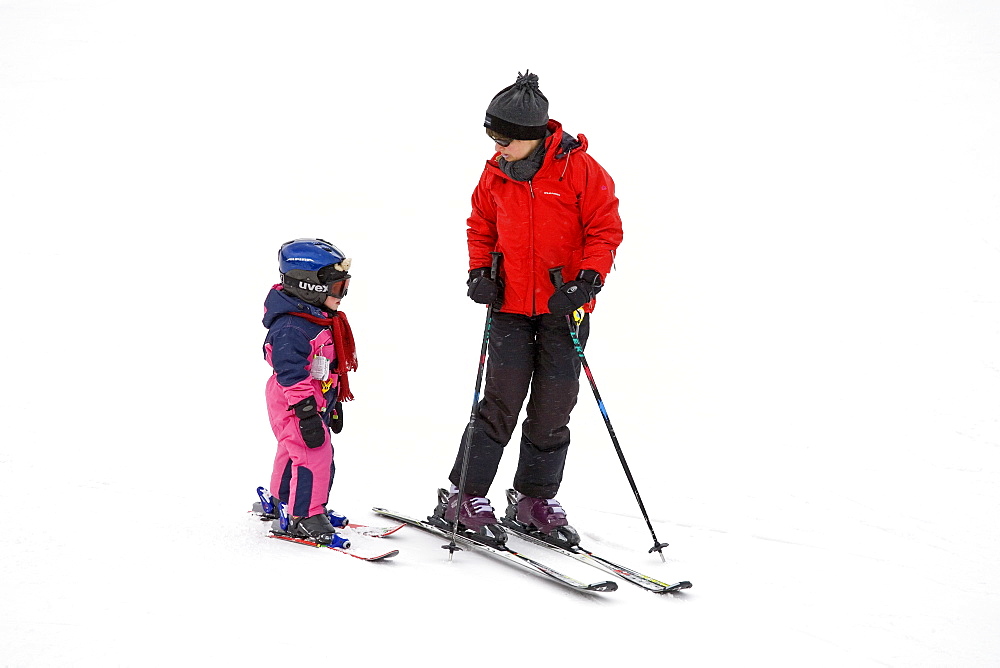 Mother teaching child to ski, Arapahoe Basin Ski Resort, Rocky Mountains, Colorado, United States of America