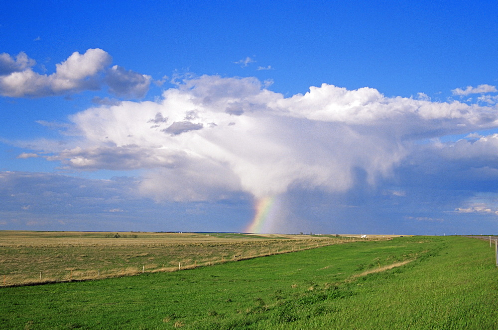 Thunderstorm and rainbow on prairie, South Dakota, United States of America, North America