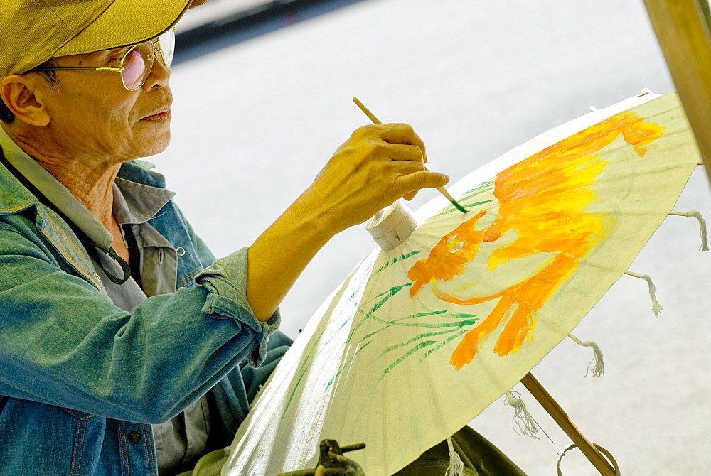 Man decorating umbrella, Borsang, Chiang Mai, Thailand, Southeast Asia, Asia