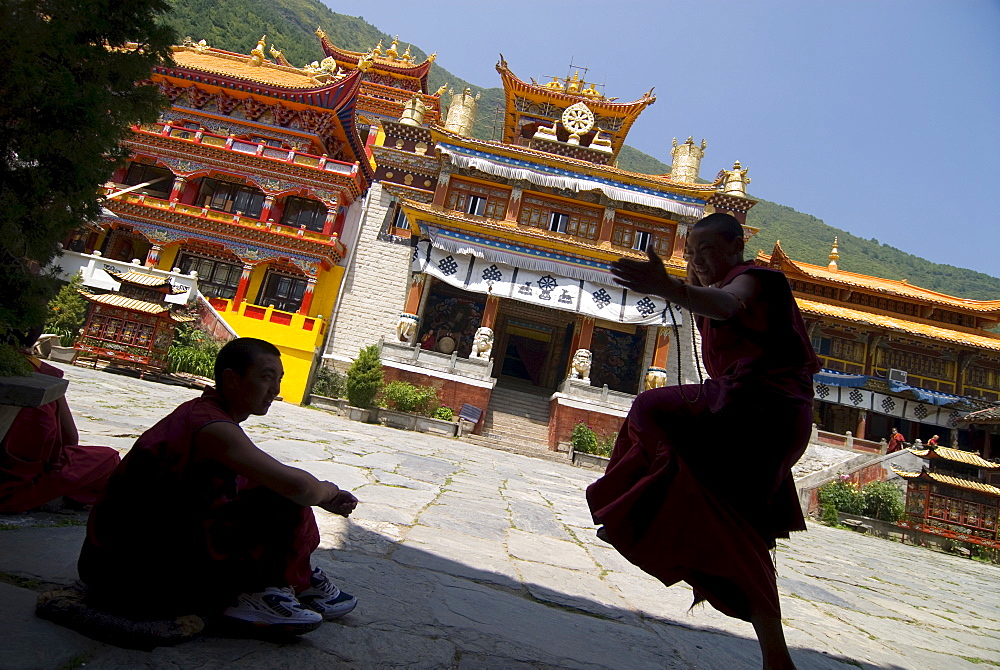 Novice Buddhist monks sparring, Nanwu temple, Kangding, Sichuan, China, Asia