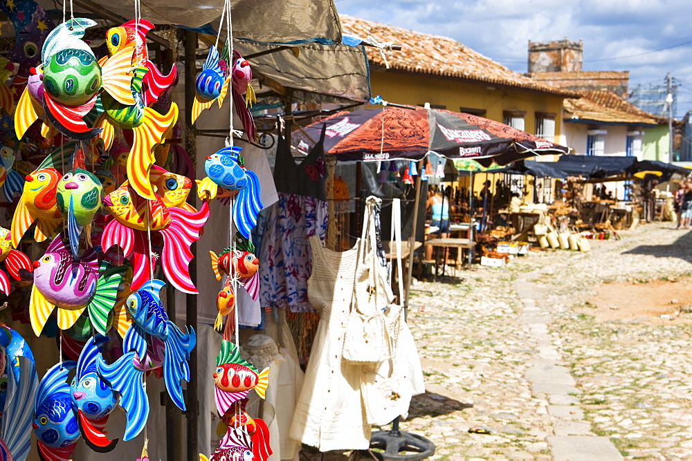 A display of colourful wooden fish for sale in a craft market in Trinidad, Sancti Spiritus Province, Cuba, West Indies, Central America