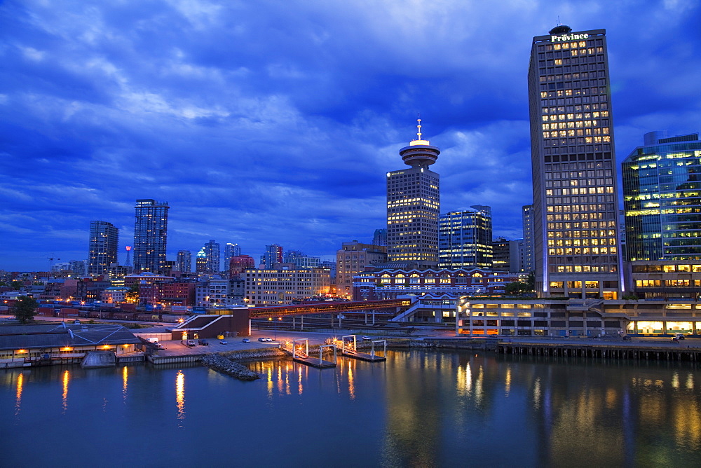 Skyline and the waterfront in the evening from Canada Place with the Seabus Terminal and Harbour Centre Tower, Vancouver, British Columbia, Canada, North America