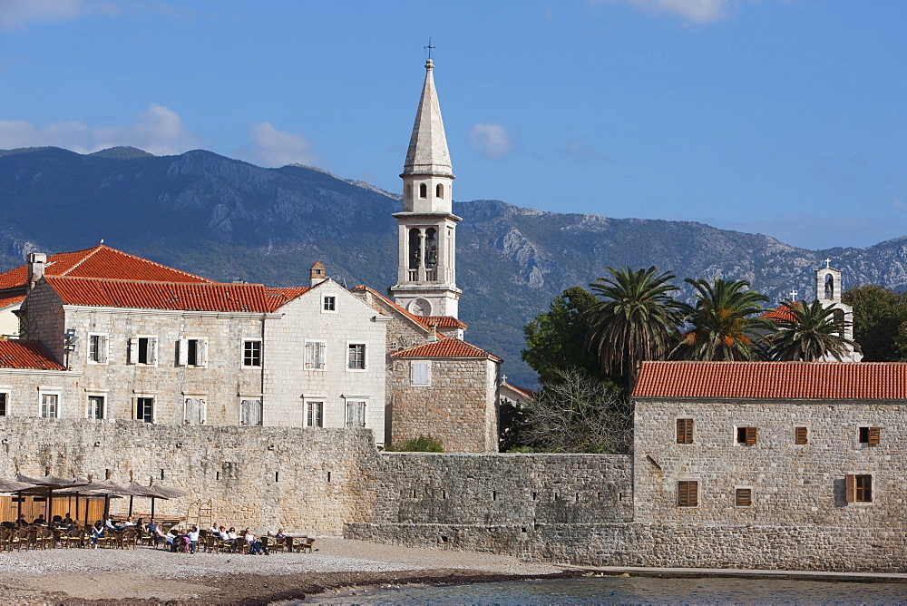 Budva fortified old town on the Adriatic coast with the tower of St. John's Church and Budva beach, Budva, Montenegro, Europe