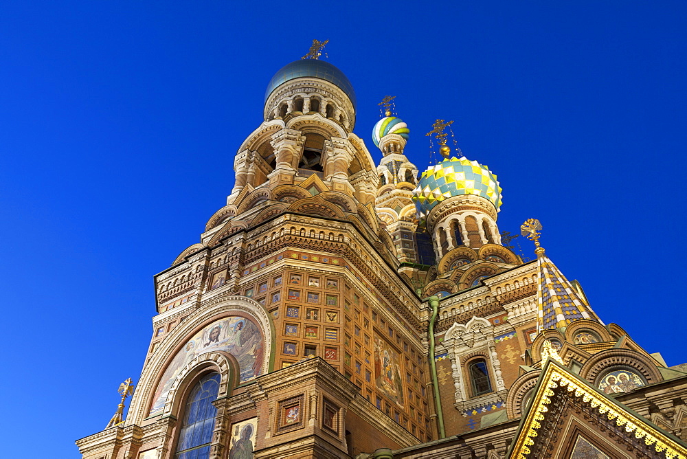 Looking up at the Church on Spilled Blood illuminated at dusk, UNESCO World Heritage Site, St. Petersburg, Russia, Europe