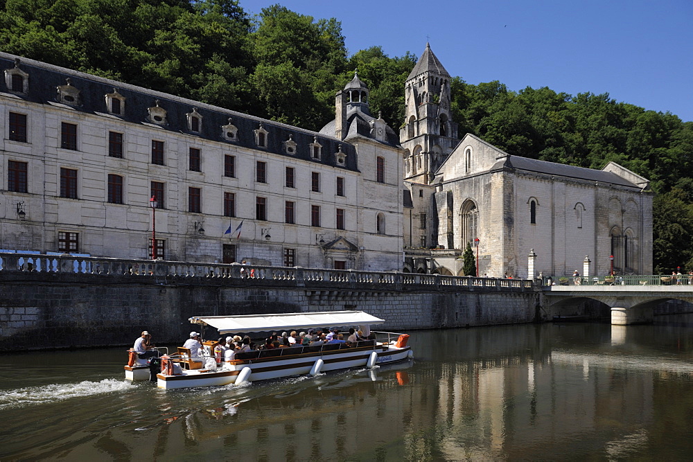 Boat passing in front of the Abbey, Brantome. Dordogne, France. Europe