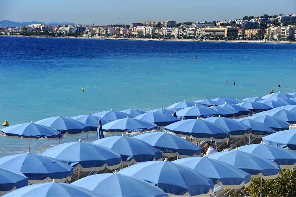 Beach umbrellas viewed from the Promenade des Anglais, Nice, Alpes Maritimes, Provence, Cote d'Azur, French Riviera, France, Mediterranean, Europe