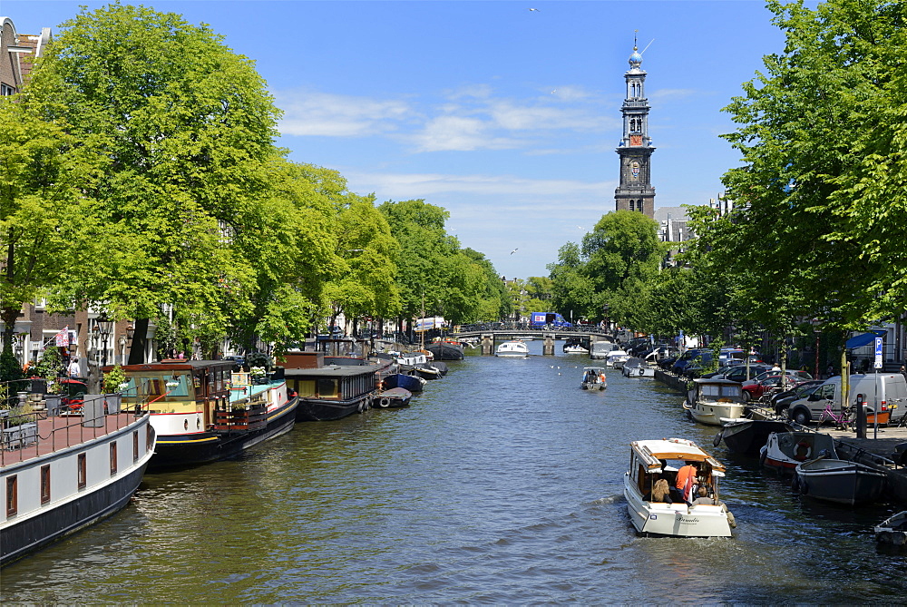 View along Prinsengracht canal, looking towards Westerkerk church, Amsterdam, North Holland, Netherlands, Europe