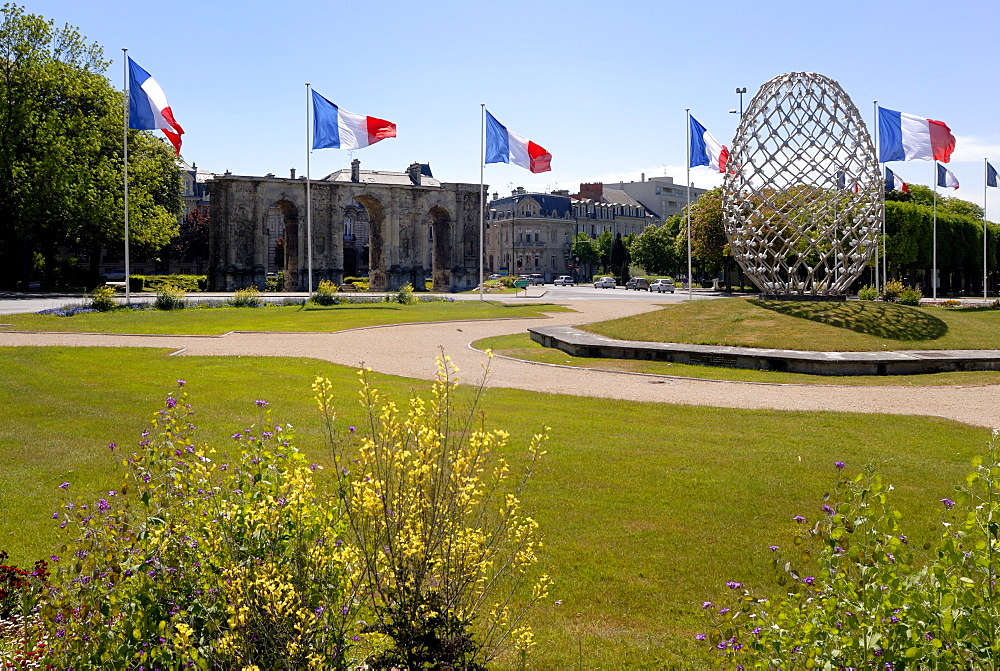 French flags and modern sculpture, Place de la Republique, looking towards Porte de Mars Roman arch, Reims, Marne, Champagne-Ardenne, France, Europe