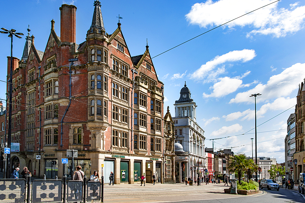 The building on the left is Parade Chambers, built between 1883-1855, as stationers and printers offices and the building on the right is the former headquarters of the Sheffield Telegraph and Star, built between 1913-16, High Street, Cathedral Quarter,