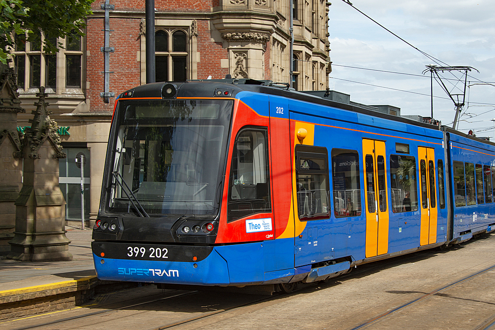 Sheffield tram known as 'Supertram' approaching a stop in Church Street, Cathedral Quarter,