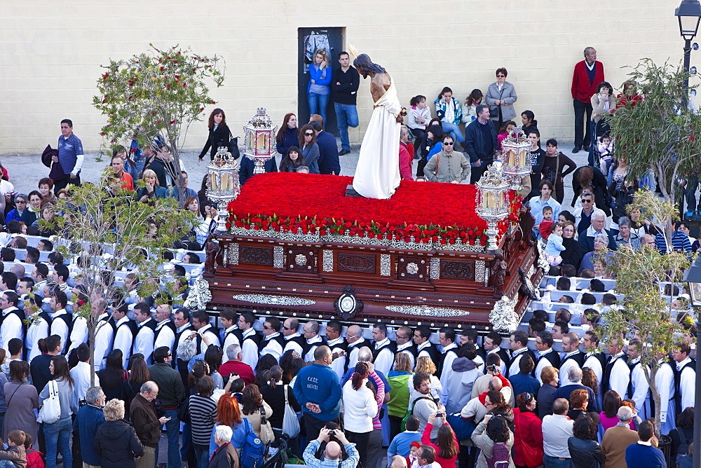 Religious float being carried through the streets during Semana Santa (Holy Week) celebrations, Malaga, Andalucia, Spain, Europe