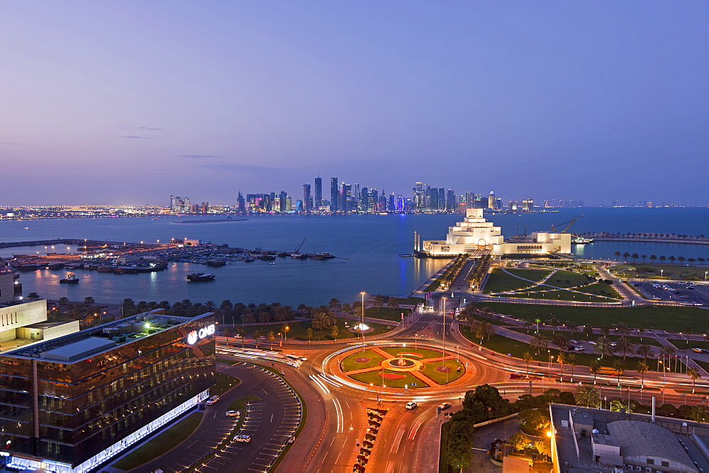 Elevated view over the Museum of Islamic Art and the Dhow harbour to the modern skyscraper skyline, Doha, Qatar, Middle East