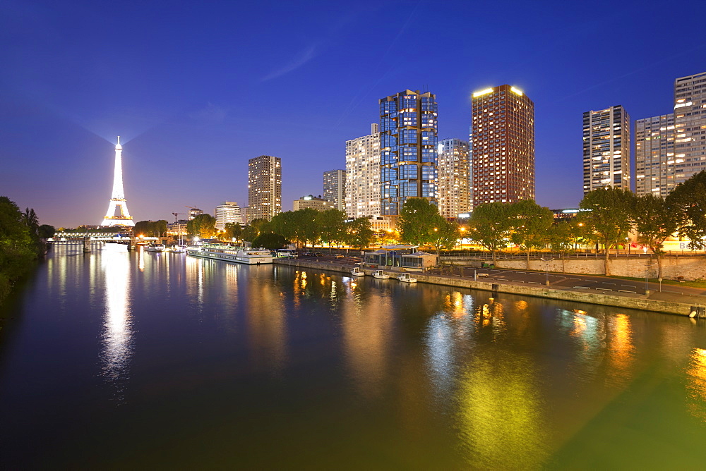 Night view of River Seine with high-rise buildings on the Left Bank, and Eiffel Tower, Paris, France, Europe