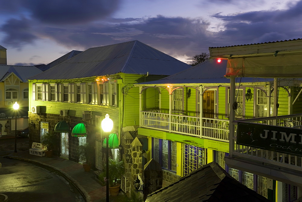 Colourful buildings surrounding the central Piccadilly Circus, illuminated at dusk, Basseterre, St. Kitts, Leeward Islands, West Indies, Caribbean, Central America