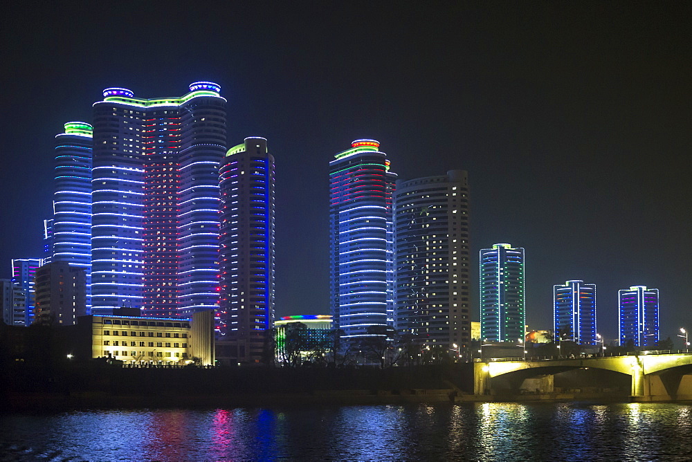 Modern city apartments illuminated at night, Pyongyang, Democratic People's Republic of Korea (DPRK), North Korea, Asia