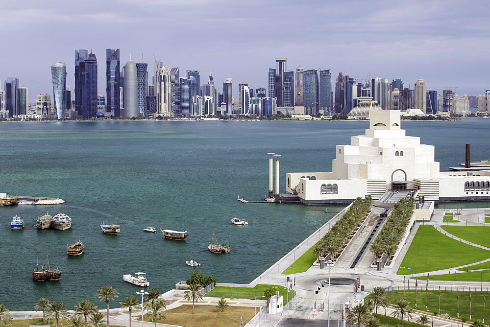 Elevated view over the Museum of Islamic Art and the Dhow harbour to the modern skyscraper skyline, Doha, Qatar, Middle East