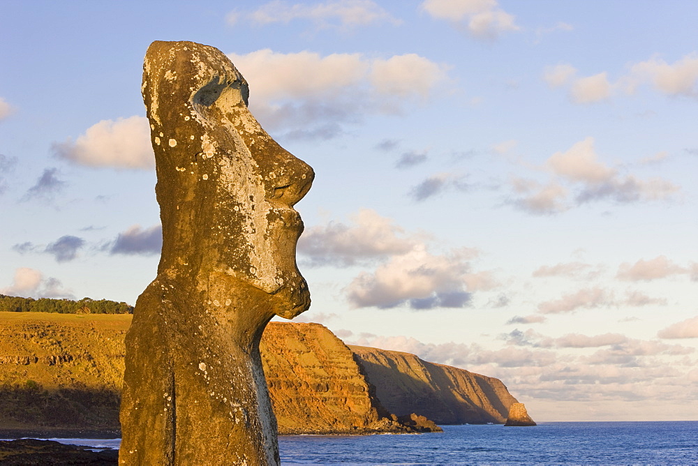 Lone monolithic giant stone Moai statue looking out to sea at Tongariki, Rapa Nui (Easter Island), UNESCO World Heritage Site, Chile, South America