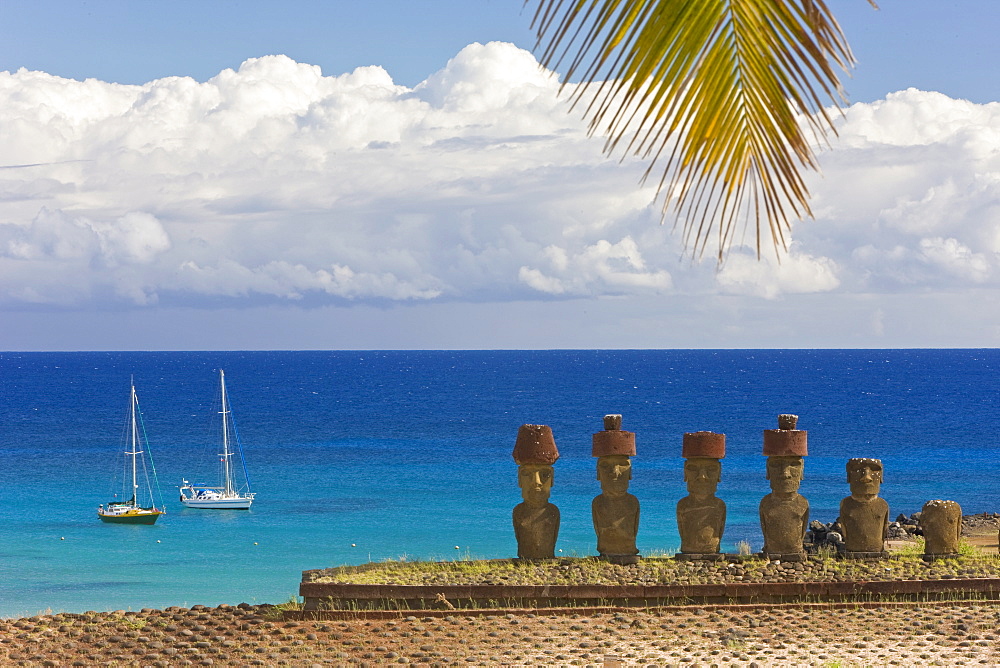 Anakena beach, yachts moored in front of the monolithic giant stone Moai statues of Ahu Nau Nau, four of which have topknots, Rapa Nui (Easter Island), UNESCO World Heritage Site, Chile, South America