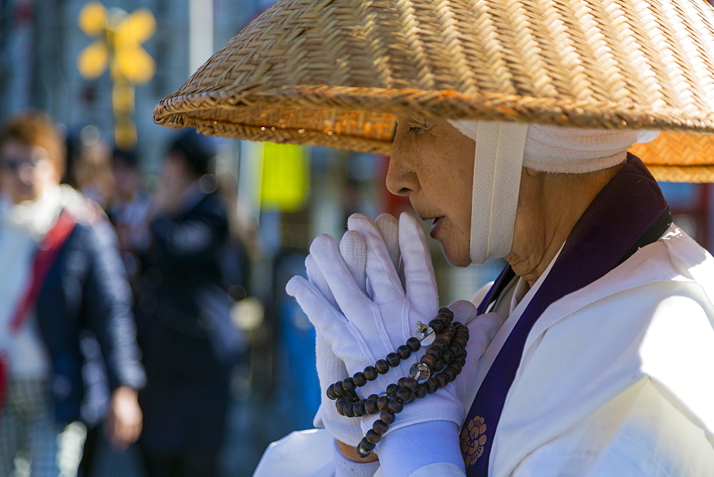 Japanese female Buddhist monk collecting alms at the Kiyomizudera Temple in Kyoto, Japan, Asia