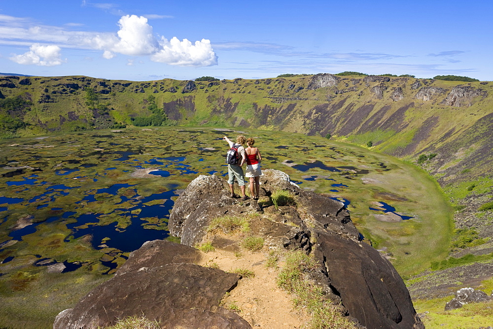 Tourists looking into the crater and view from the rim into the crater of Ranu Kau, Rapa Nui (Easter Island), Chile, South America