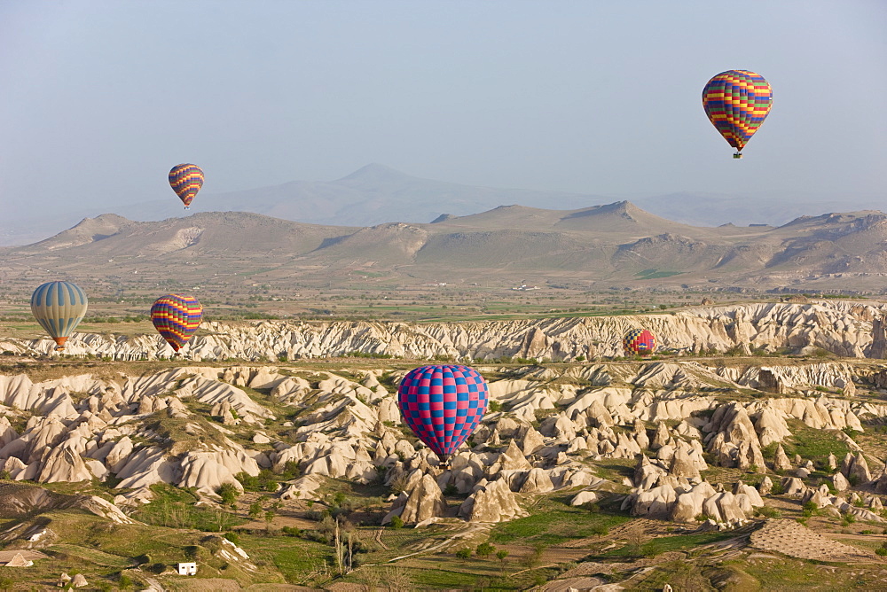 Hot air balloon flight over the famous volcanic tufa rock formations around Goreme, Cappadocia, Anatolia, Turkey, Asia Minor, Eurasia