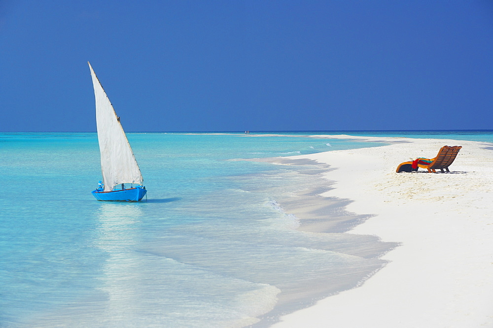 Traditional dhoni and lounge chairs on beach, Maldives, Indian Ocean, Asia